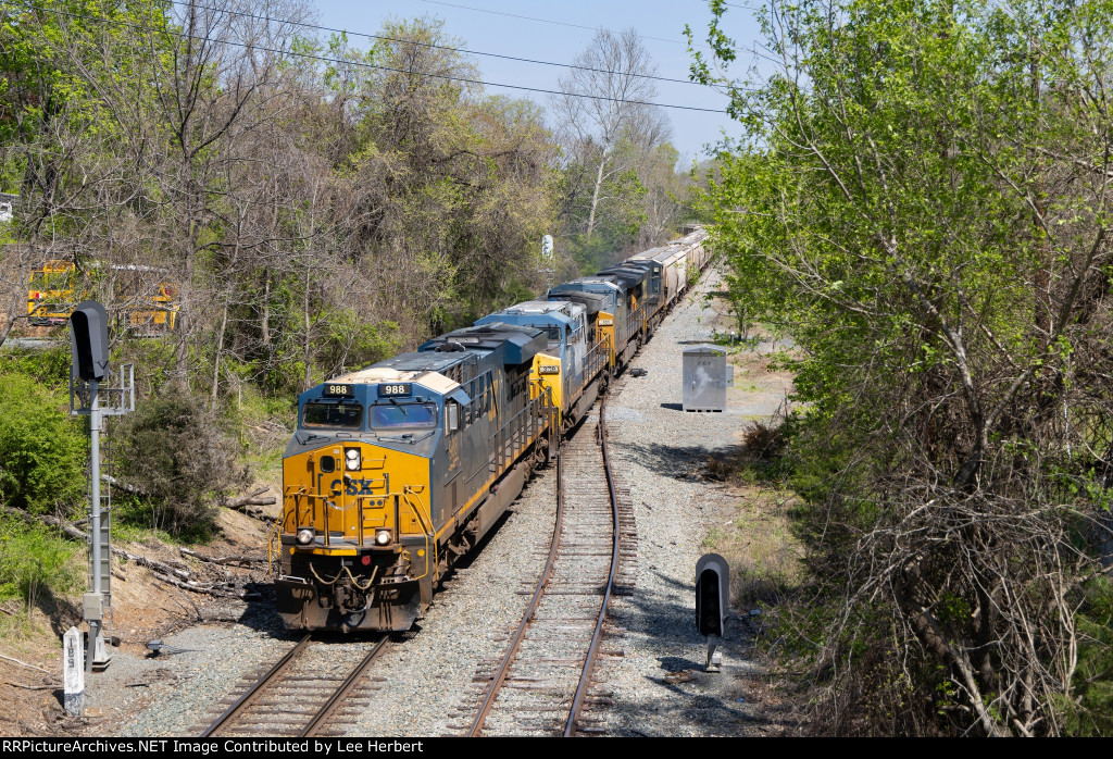CSX 988 leading an empty grain train westward